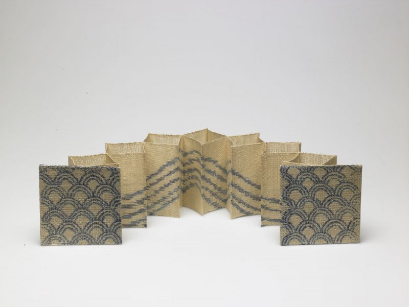 Woven book with blue designs.