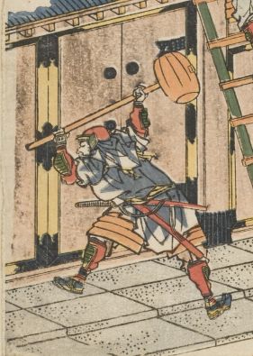 Detail of a man hammering down a door.