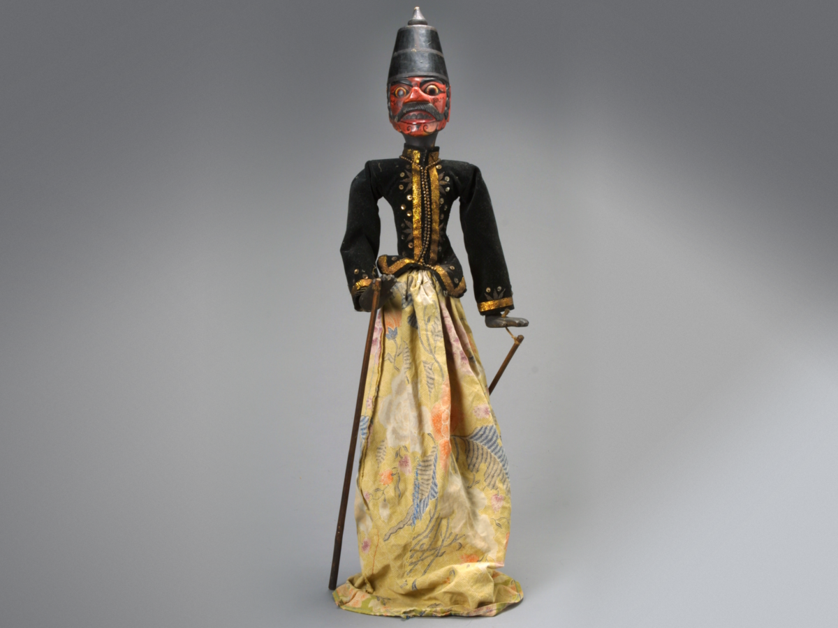 Puppet with red face and black hat.