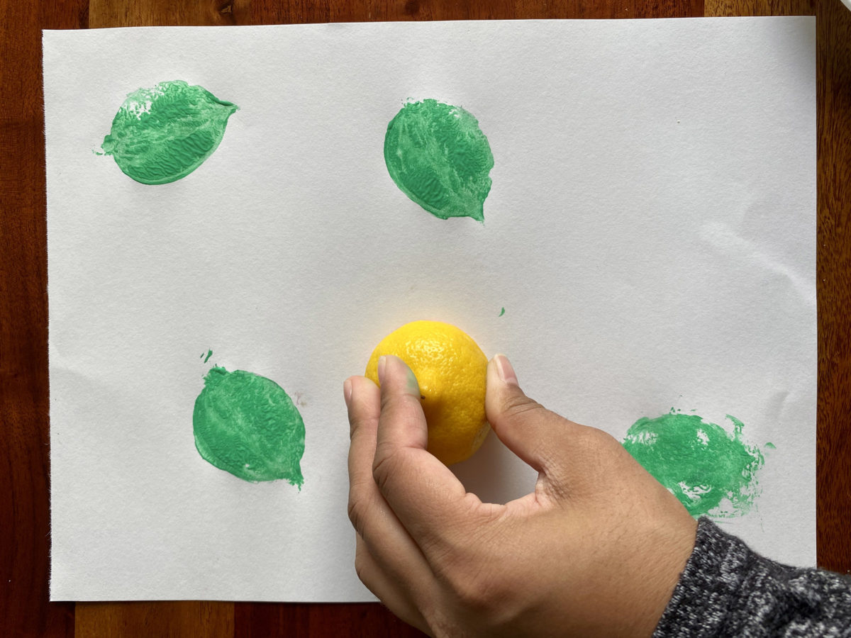 Detail view of painted vegetable stamp activity.